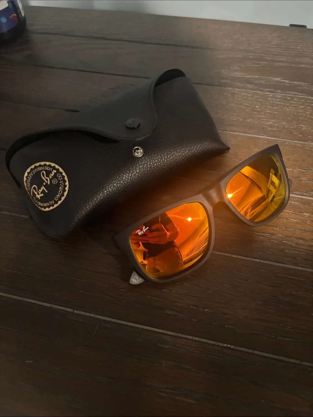 Ray-Ban “Justin” Black Frame Sunglasses with Orange Mirrored Lenses